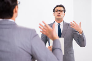 a person practicing speech in front of the mirror